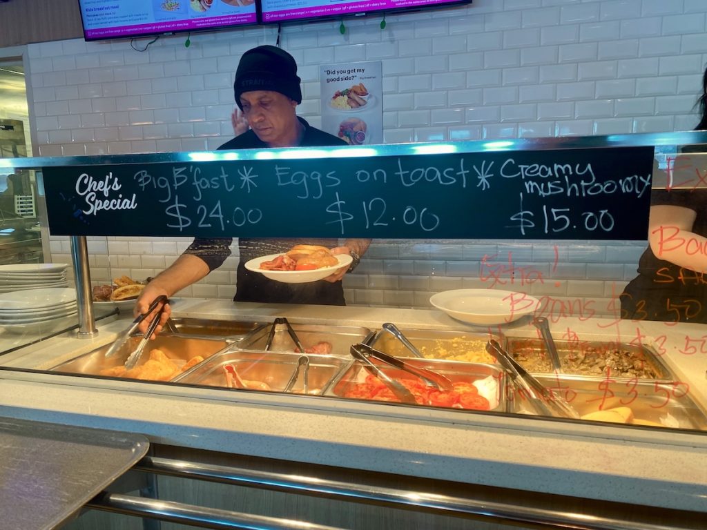 Man serving Bluebridge breakfast.